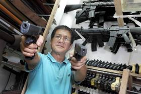THE REAL DEAL: The real Glock G19 pistol is in Mr Jimmy Low&#039;s right hand. 