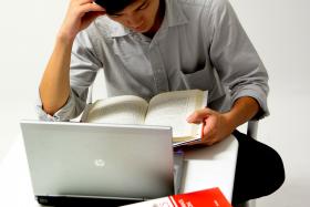 File photo of man studying. A man who was the target of a police manhunt in Copenhagen on Thursday turned out to be a student suffering from pre-exam jitters while reading a book about terrorism. 