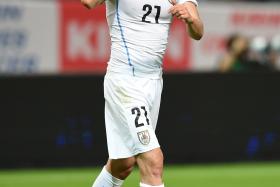 Edinson Cavani celebrates after scoring Uruguay&#039;s first goal against Japan on Friday. 