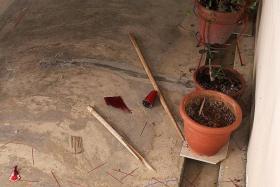 MESS: Debris at the front of Mr Koh&#039;s house, including the snapped wooden stick the woman had used to break the joss-stick holder. 