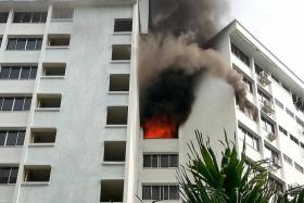 BURNT: Many residents in Block 367, Yishun Ring Road, evacuated their homes after smelling smoke. No one was hurt in the fire.