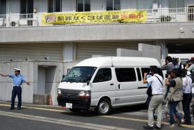 A van carrying a 15-year-old high schoolgirl, who was arrested on suspicion of killing a school friend at her home, leaves a police station for the prosecutor&#039;s office in Sasebo in Nagasaki prefecture, on Japan&#039;s southern island of Kyushu on July 28, 2014. 