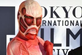 A character from Japanese manga Attack on Titan poses on the red carpet for the 27th Tokyo International Film Festival opening ceremony in Tokyo on October 23, 2014.