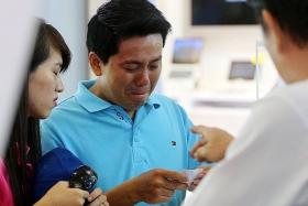 TEARS: After paying $950 for an iPhone 6 for his girlfriend, Vietnamese tourist Pham Van Thoai was made to pay an additional $1,500 by Mobile Air for the phone&#039;s warranty. Staff members refused to refund him when he asked, even after he begged them in tears.