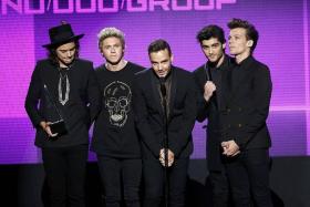 POPULAR: One Direction accepting the award for favourite pop/rock band duo or group during the 42nd American Music Awards in Los Angeles on Sunday.