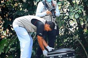 Penang Hospital forensic personnel taking the bag with body part to the hospital for a post mortem last month (Nov). 