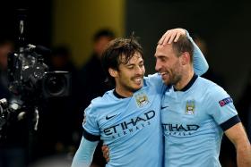Manchester City midfielder David Silva (L) and defender Pablo Zabaleta celebrate after winning 2-0 against AS Roma. 