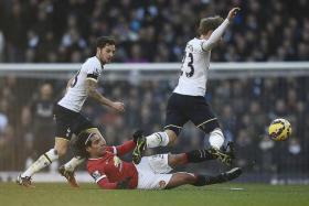TACKLE: Man United&#039;s Radamel Falcao (centre) challenging Tottenham&#039;s Christian Eriksen (right) during their match.