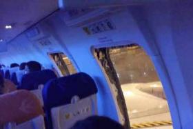Unhappy at the flight delay, Chinese passengers took matters into their own hands - by yanking open the plane's emergency doors.