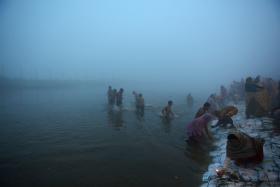 Hindu devotees taking a dip for the Makar Sankranti festival at Sangam, the confluence of the rivers Ganges, Yamuna and the mythical Saraswati, during a cold morning in Allahabad on Wednesday.