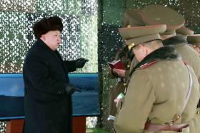 This undated picture released from North Korea&#039;s official Korean Central News Agency (KCNA) on Feb 21 shows North Korean leader Kim Jong-Un (L) inspecting a drill for striking and seizing island at an undisclosed location in North Korea.