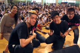 INSPIRING: Shigga Shay and Gentle Bones pose for a picture with the event&#039;s emcees and students at Bishan Park Secondary School (above) yesterday. 