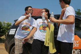 BE COOL: Participant Alvin Yeong and his family quenched their thirst with isotonic drinks when they took part in the 2014 The New Paper SUVival Challenge.  