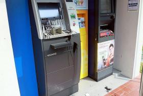STAINED: One of the ATMs found splashed with black paint.