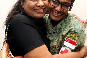 BACK HOME: Military Expert 1 Shorini Dhurgha, 24, a military medical expert, being welcomed home by her mother.