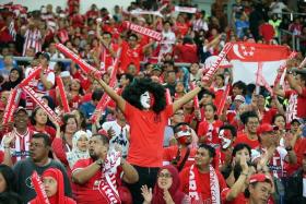 ROAR: The Singaporean fans making themselves heard at the Bukit Jalil Stadium last night.  