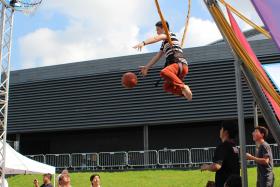 TAKE A SHOT: Flying Dunk booth at the SEA Games Carnival, where participants shoot hoops while on a Euro bungee.