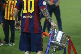YET ANOTHER ONE: The Cup runneth over for Messi (above).  