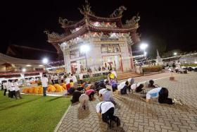 RITE: Led by Buddhist monks, devotees join in the &#039;three-step, one-bow&#039; ceremony.