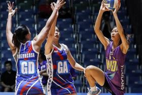 ON THE RISE: Remia Buenacosa (far left) and Ana Cenarosa of the Philippines in action in the netball preliminary round competition.