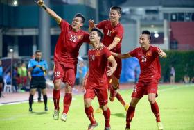 VICTORIOUS VIETNAM: Vietnam&#039;s Nguyen Cong Phuong (right, No. 10) celebrating with his teammates and their fans