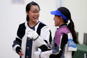Tessa Neo celebrates with teammate Jasmine Ser after winning the women&#039;s 10m air rifle individual event of the 28th SEA Games.