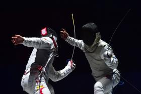  Kevin Jerrold Chan of Singapore (L) competes against Nathaniel Perez of the Philippines 