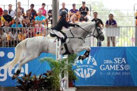 Singapore rider Cheong Su Yen in action during the equestrian jumping event of the 28th SEA Games.