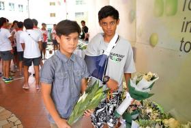 FAREWELL: Tristan So Kwan Wing (left) and Arnaav Chabria (right) paying tribute to their friends and teacher at Tanjong Katong Primary School.   