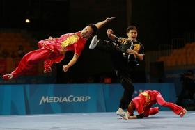 TEAMWORK: Singapore&#039;s wushu exponents in action in the men&#039;s duel barehand final yesterday.  