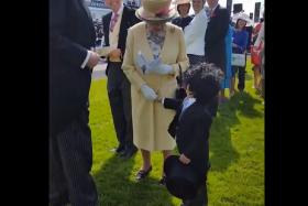 Mohammed Ahmed Jaber Al Harbi shakes the hand of Queen Elizabeth II at the Epsom Derby in Dubai.