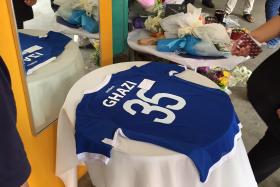 POIGNANT: At TKPS, a blue jersey with Mr Ghazi’s name was laid out on a table, with a special note pinned on it.
