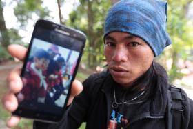 Mount Kinabalu guide Mohd Rizuan Kauhinin will travel to Singapore to meet the boy he rescued.