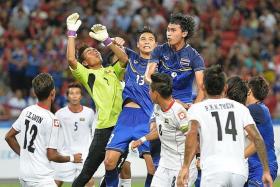 HEROES: Playmaker Chanathip Songkrasin is the standout player for Thailand at the SEA Games while Myanmar goalkeeper Phyo Kyaw Zin (above in yellow) helps his team from suffering a heavier defeat.  