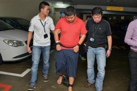 SUSPECTS: Myanmar national Phyo Min Naing and Singapore permanent resident Zaw Min Hlaing (above, in restraints) were taken to the alleged crime scene yesterday. 