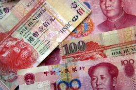 File photo of yuan notes and Hong Kong dollar notes.