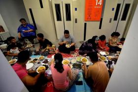 MAKAN: The residents of the 14th floor of Block 591A Montreal Link, share a meal during the breaking of the fast.