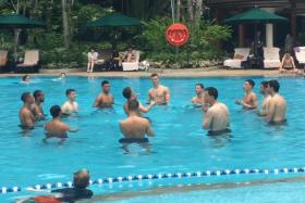 Arsenal players indulge in a game of keepy uppy in the Shangri-La Hotel pool.