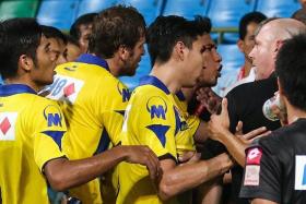FRACAS: Tampines players, led by Noh Alam Shah (second from far right), confronting Brunei DPMM coach Steve Kean (far right) after the game.