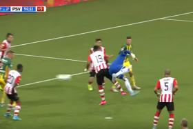 ADO Den Haag goalkeeper Martin Hansen (in blue) scores his side&#039;s late equaliser against PSV with his heel.