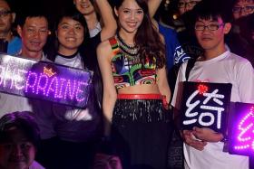 POPULAR: Getai singer Sherraine Law with fans carrying placards spelling out her name in lights at her performance at a getai event at Sin Ming Lane on Wednesday.