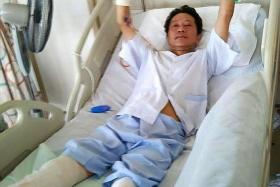 FIGHTER: Mr Tan Whee Boon is recovering in hospital after his legs were amputated two days ago. His hands were removed last Friday.