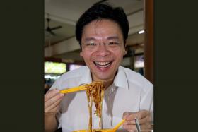 GOOD COOK: Mr Lawrence Wong, digging into the lor mee at the S-11 coffee shop in Choa Chu Kang Drive. He reveals that he is quite good at cooking. 