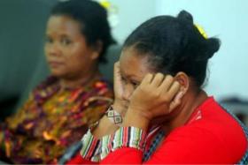 A concerned Orang Asli parent waiting for news of her missing child.