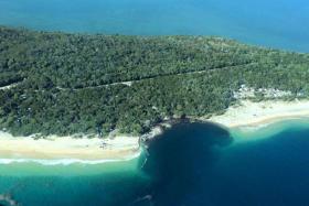 A sinkhole at a camping spot near Queensland's Rainbow Beach swallowed several vehicles.