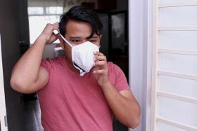 FAN POWER: Mr Mohd Taufiq, 28, went to his Residents&#039; Committee to collect two N95 masks for his mother and himself.