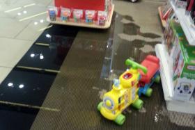 WET: Water spilling into at Lamkins, a toy store on the third level of Seletar Mall.