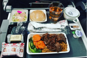 An Instagram photo by @kokpowa of fried noodles and braised beef on Singapore Airlines.