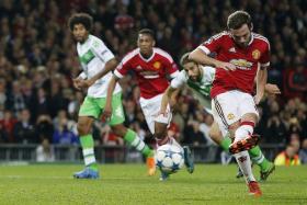 LEVELLER: Juan Mata (right) scoring the penalty to give Man United the equaliser in the  34th minute.