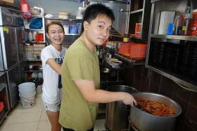 GEN Y: Mr Aw Chee Wei (above) and his girlfriend, Ms Wee Qing Xiu, cook up unique versions of the carrot cake such as the cheese carrot cake and carrot cake topped with pork floss sitting on a bed of tom yum sauce.